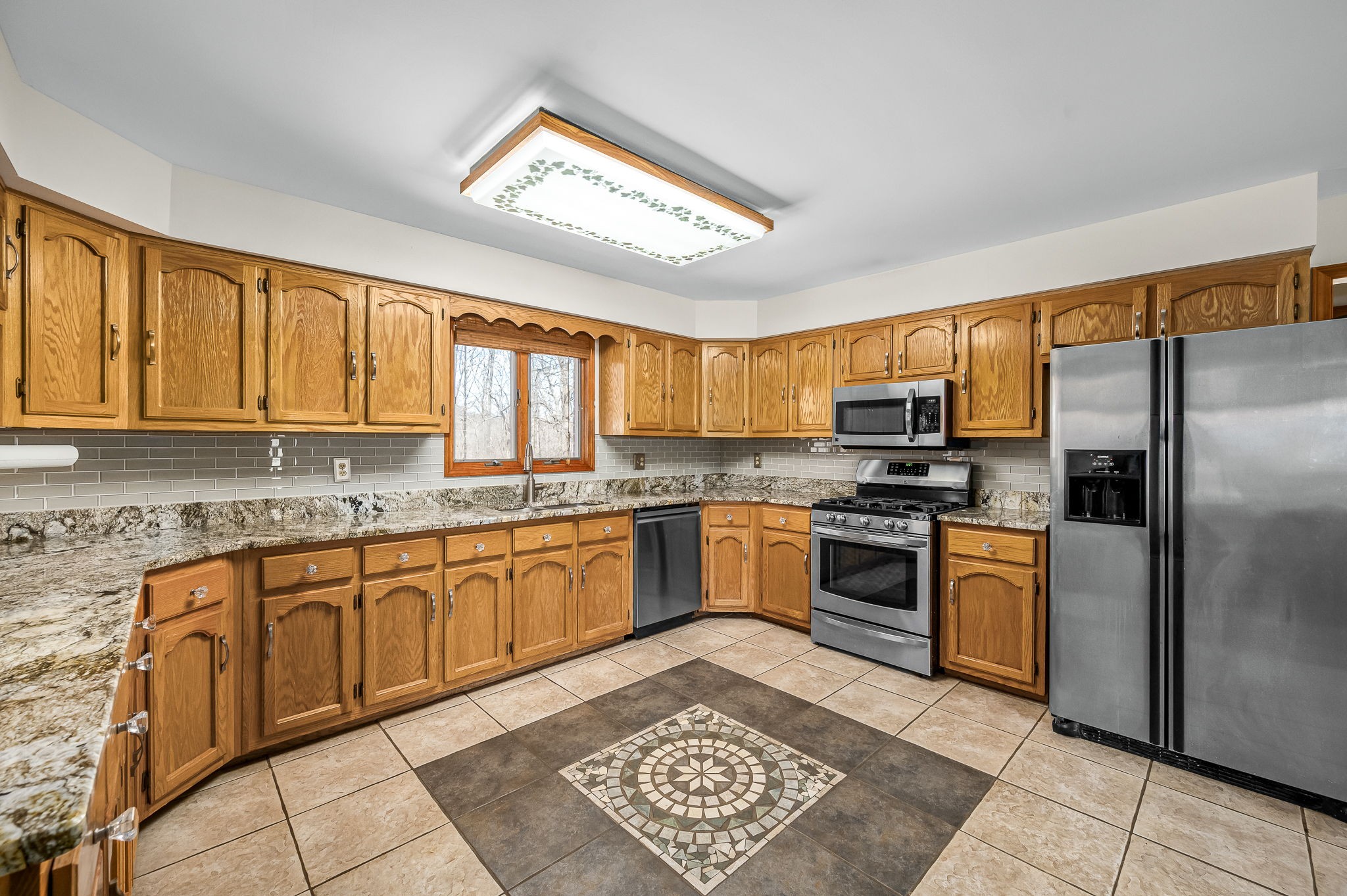 1246 Oakwood Road Joelton, TN 37080 - Photo 10 of 61 a kitchen with stainless steel appliances granite countertop a refrigerator a sink dishwasher a stove with wooden cabinets and floor