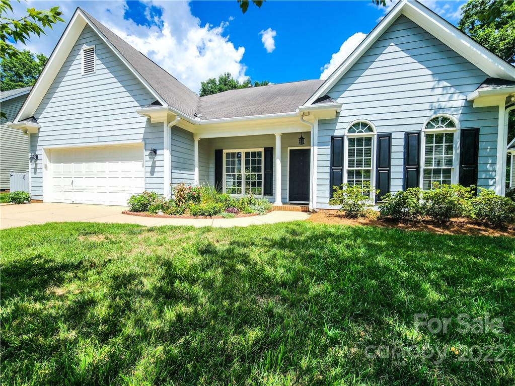 a view of a house with pool and garden