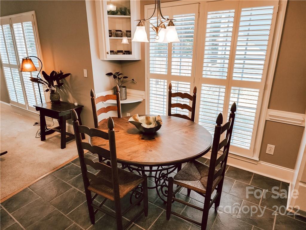 8408 Forest Shadow Circle Cornelius, NC 28031 - Photo 5 of 24 a view of a dining room with furniture and a window