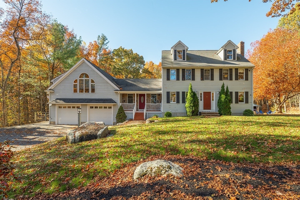 46 Long Pond Road Tyngsborough, MA 01879 - Photo 1 of 41 a front view of a house with a garden