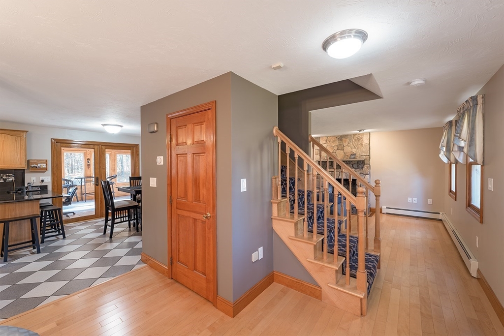 46 Long Pond Road Tyngsborough, MA 01879 - Photo 16 of 41 a view of a livingroom with furniture staircase and kitchen view