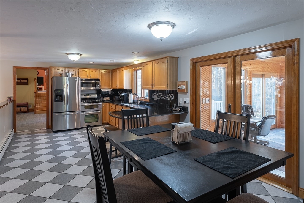 46 Long Pond Road Tyngsborough, MA 01879 - Photo 19 of 41 a view of a dining room with furniture window and outside view