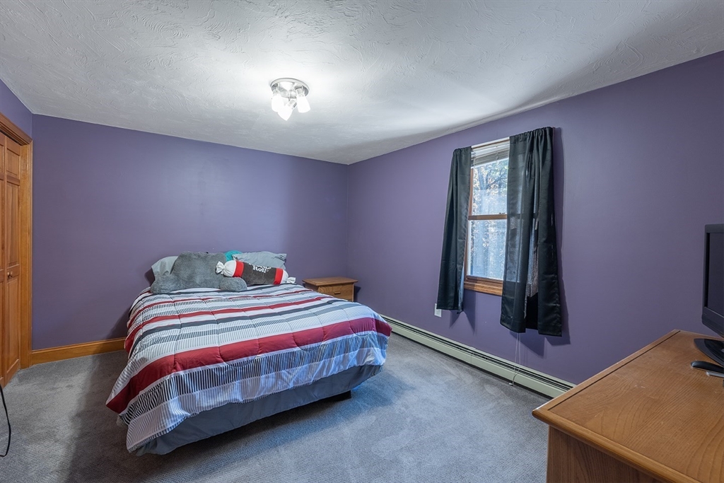 46 Long Pond Road Tyngsborough, MA 01879 - Photo 34 of 41 a bedroom with a bed and a window