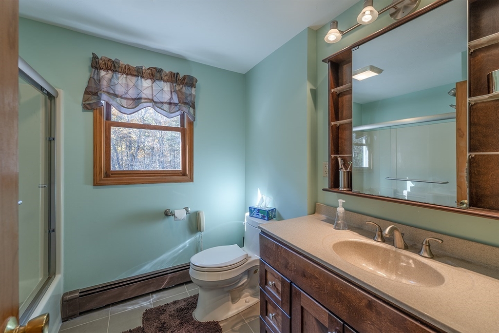 46 Long Pond Road Tyngsborough, MA 01879 - Photo 35 of 41 a bathroom with a toilet sink and mirror