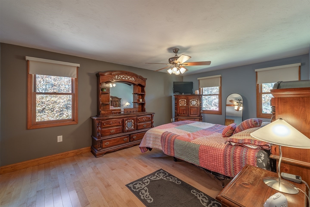 46 Long Pond Road Tyngsborough, MA 01879 - Photo 36 of 41 a bedroom with a bed and wooden floor