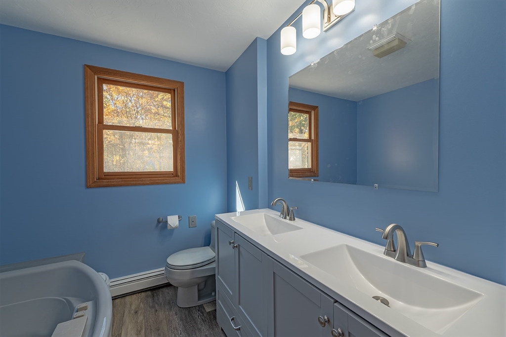 46 Long Pond Road Tyngsborough, MA 01879 - Photo 41 of 41 a bathroom with a toilet a sink and mirror