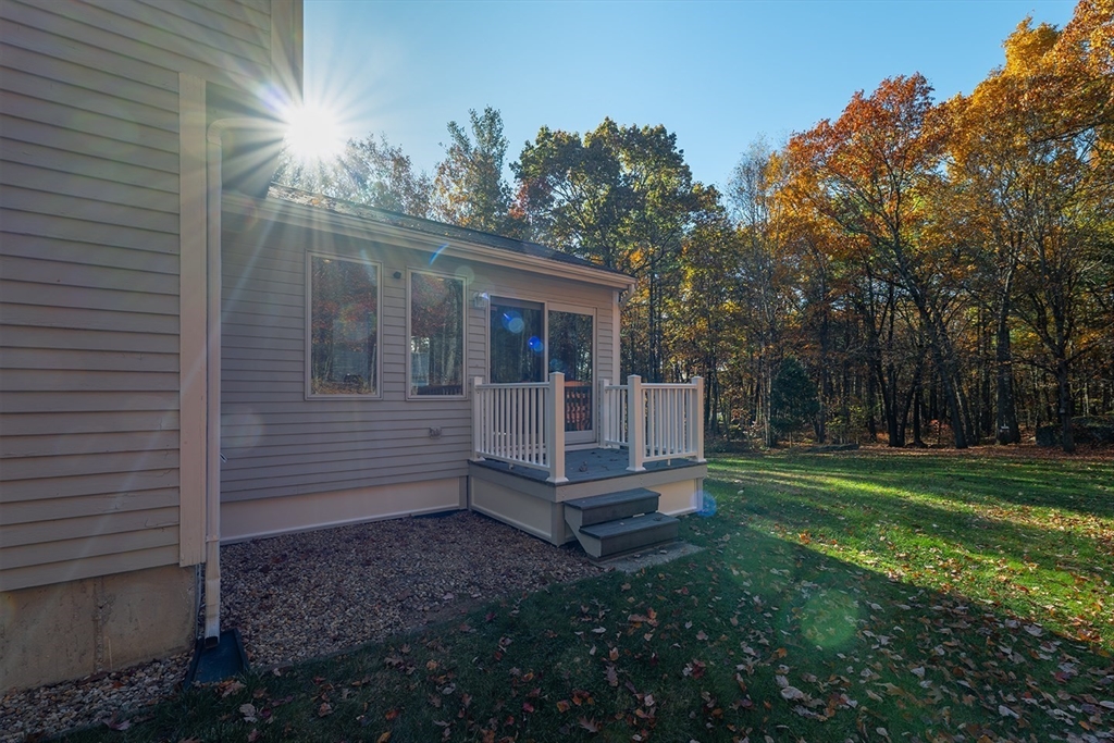 46 Long Pond Road Tyngsborough, MA 01879 - Photo 10 of 41 a view of a small house with a yard
