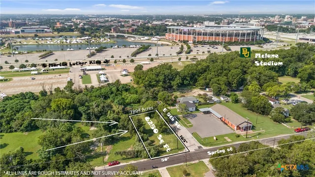 an aerial view of residential houses with outdoor space and river