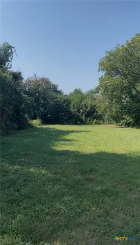 a view of a green field with clear sky