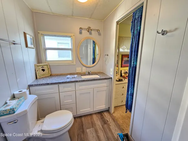 a bathroom with a toilet a sink and a mirror