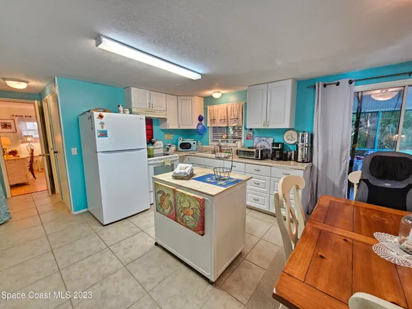 a kitchen with stainless steel appliances a stove a refrigerator a sink a counter top space and cabinets