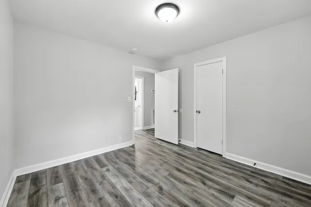 a view of a room with wooden floor