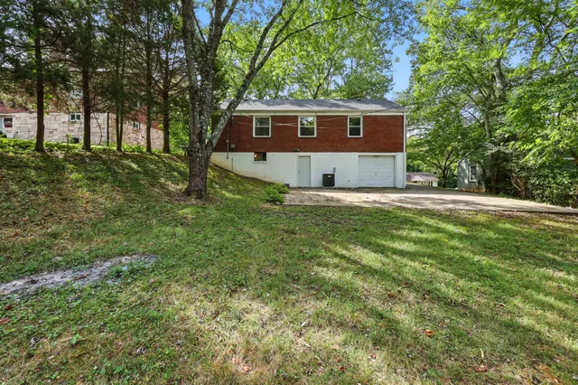 a house is sitting in middle of forest