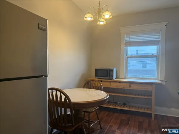 a view of a dining room with furniture wooden floor and chandelier