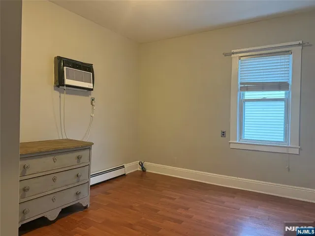a view of an empty room and wooden floor