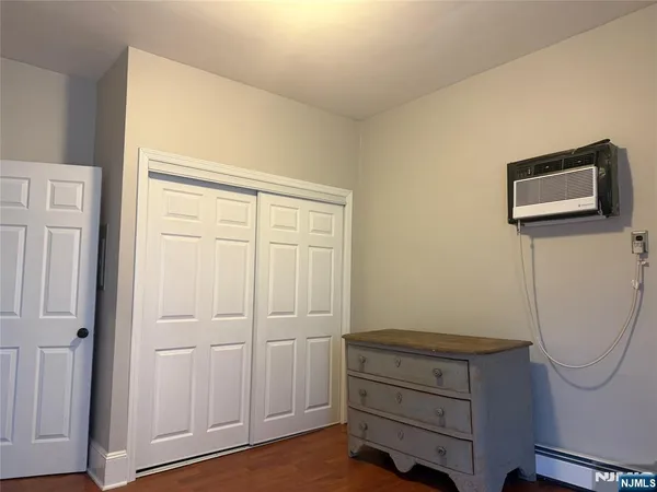 a room with a wooden floor and white walls