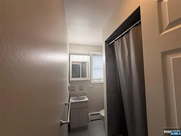 a kitchen that has a refrigerator and a wooden floor