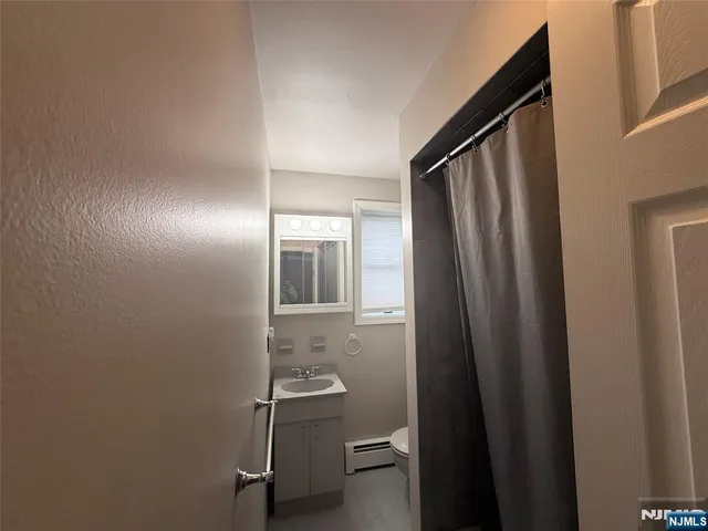 a kitchen that has a refrigerator and a wooden floor