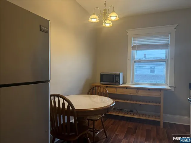 a view of a dining room with furniture wooden floor and a chandelier
