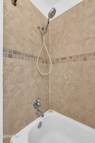 a bathroom with a shower and a sink