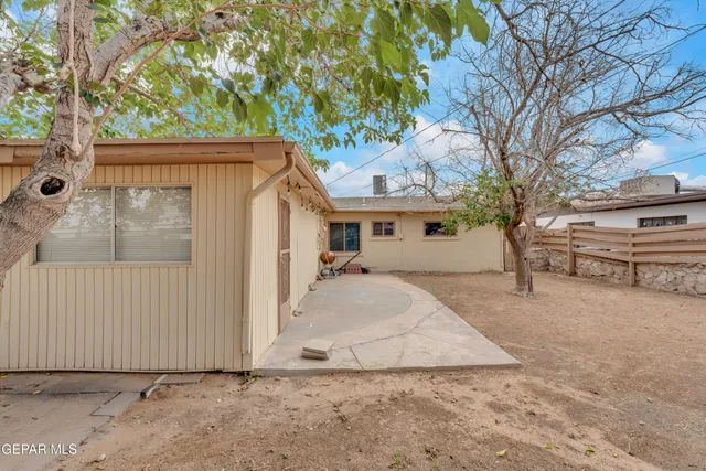 a view of a house with a tree in front