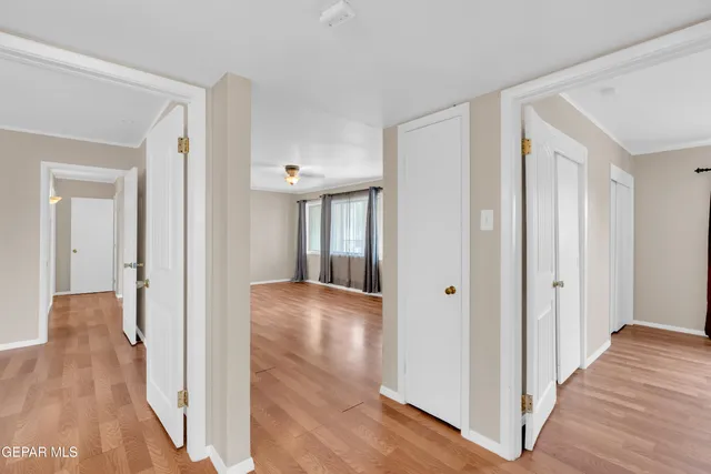 a view of a hallway with wooden floor