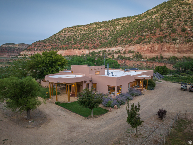 1035 Montezuma Creek Road Monticello, UT 84535 - Photo 7 of 27 Southwestern-style residence featuring a stucco exterior and a flat roofline