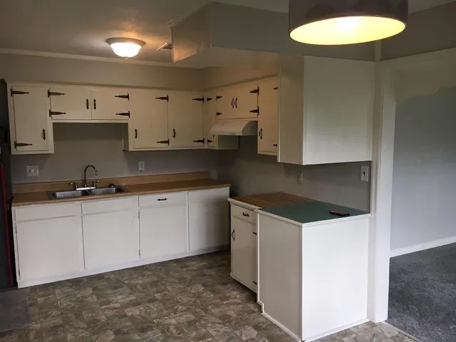 a kitchen with stainless steel appliances granite countertop a sink and a stove