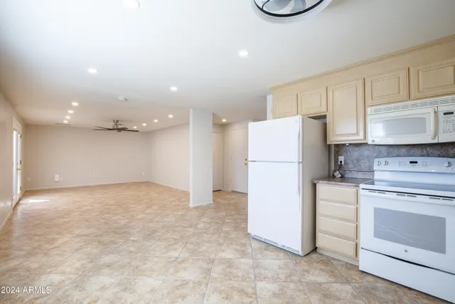 a kitchen with a refrigerator and a stove top oven