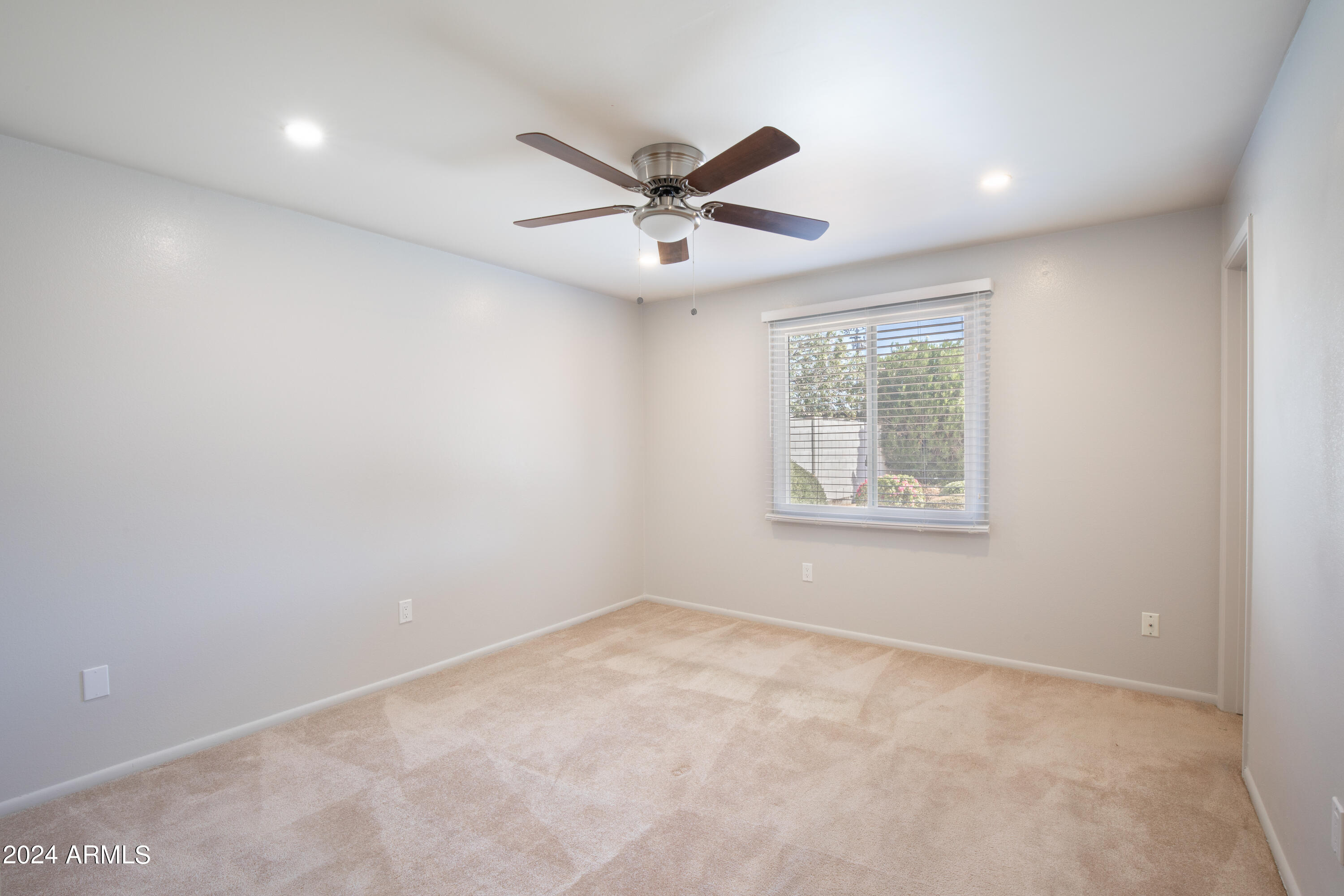 14225 North 39th Way Phoenix, AZ 85032 - Photo 17 of 23 en empty room with windows and ceiling fan