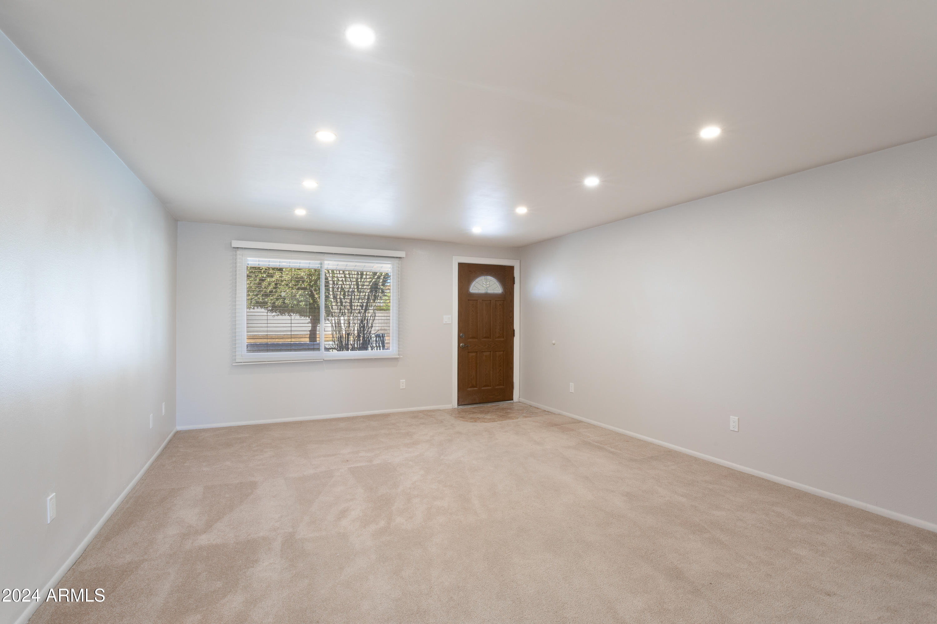14225 North 39th Way Phoenix, AZ 85032 - Photo 3 of 23 a view of an empty room with a window