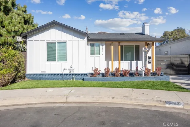 a front view of a house with a yard and outdoor space