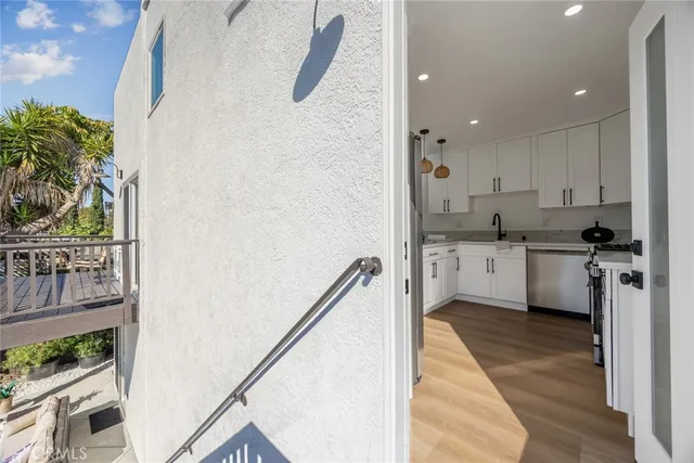 a kitchen with cabinets and wooden floor