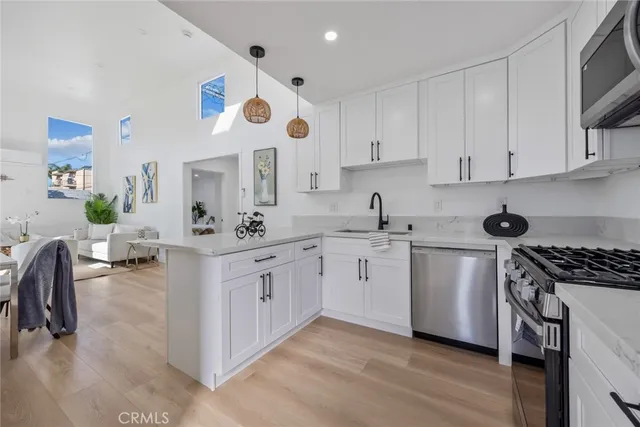 a kitchen with stainless steel appliances a refrigerator and a stove top oven