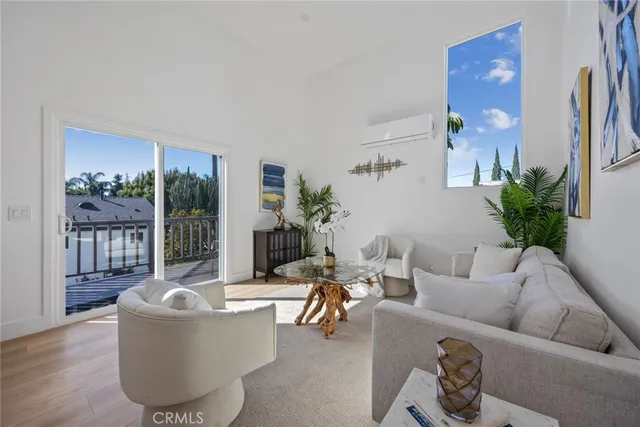 a living room with furniture and potted plant