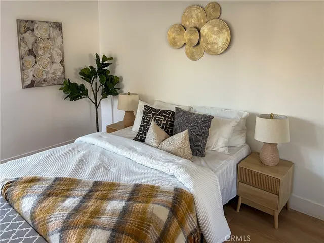 a bedroom with bed and a plant