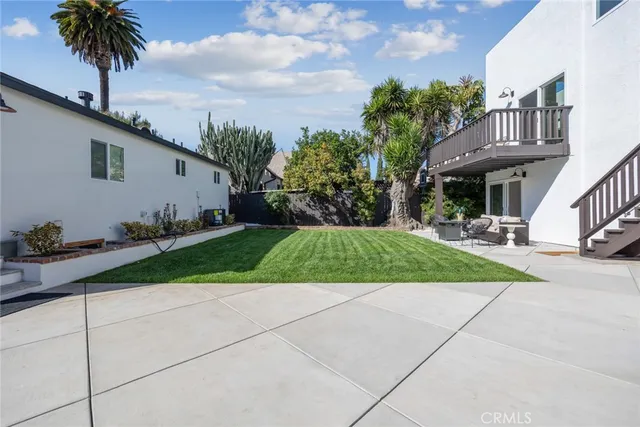 a backyard of a house with potted plants