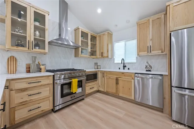 a kitchen with stainless steel appliances granite countertop a stove and a sink