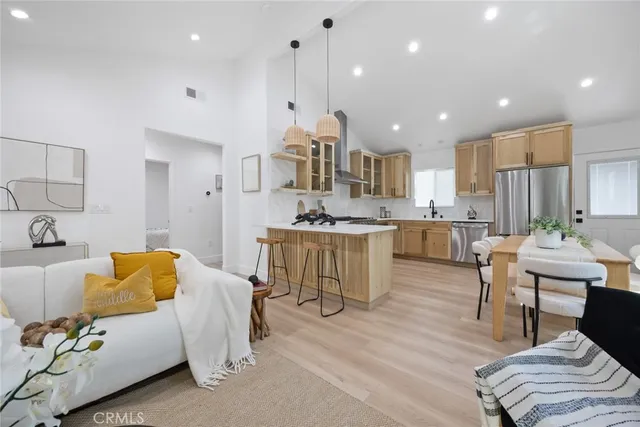 a living room with kitchen island furniture and a wooden floor