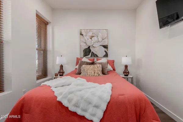 a bedroom with a bed and wooden floor