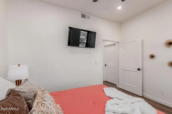 a bedroom with a bed and flat screen tv