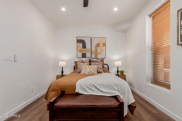 a bedroom with a bed and wooden floor