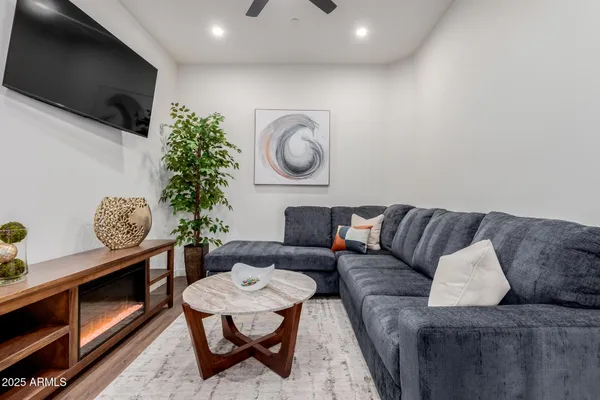 a living room with furniture a clock and a chandelier