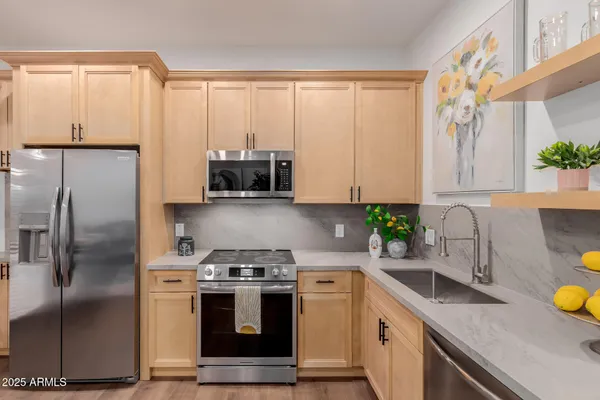 a kitchen with stainless steel appliances a stove a microwave and cabinets