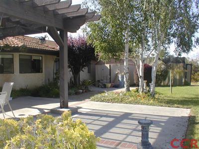 5780 Robin Court Santa Maria, CA 93455 - Photo 7 of 15 a backyard of a house with barbeque oven table and chairs