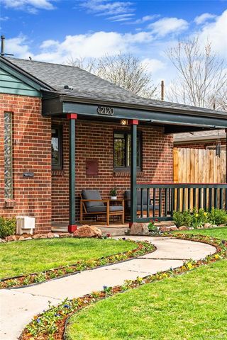 a view of a house with a yard and sitting area
