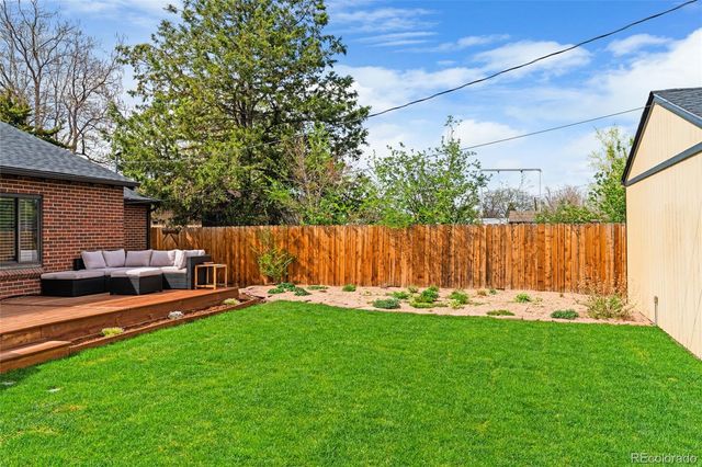 a view of a house with a yard and sitting area