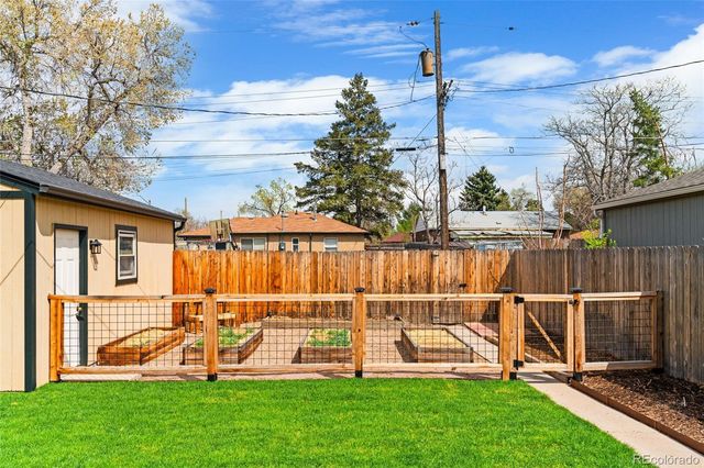 a view of backyard with wooden deck and outdoor seating