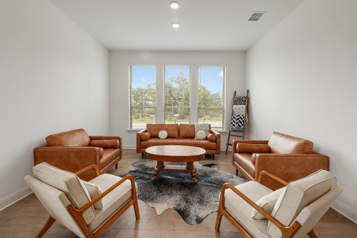 100 Garden Rose Pass Georgetown, TX 78628 - Photo 17 of 39 a living room with furniture and a window
