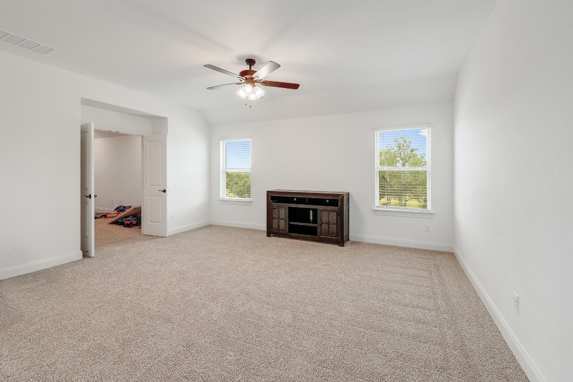 100 Garden Rose Pass Georgetown, TX 78628 - Photo 23 of 39 an empty room with windows and fireplace